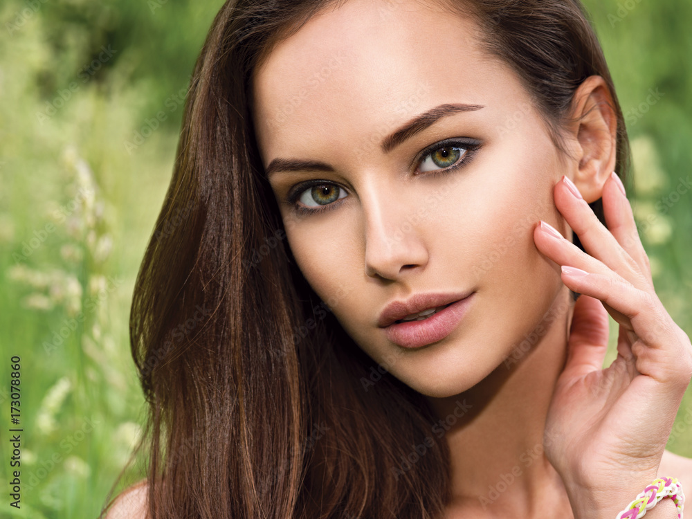 Fototapeta premium portrait of the young beautiful woman with long hairs. outdoors.