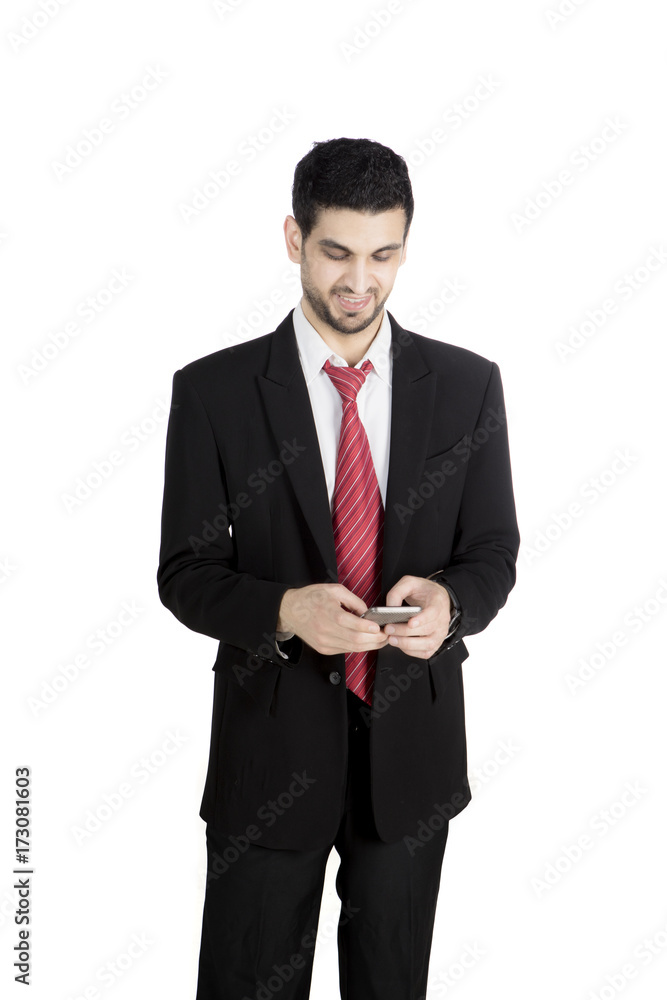 Italian businessman using a smartphone on studio Italian businessman using a smartphone on studio