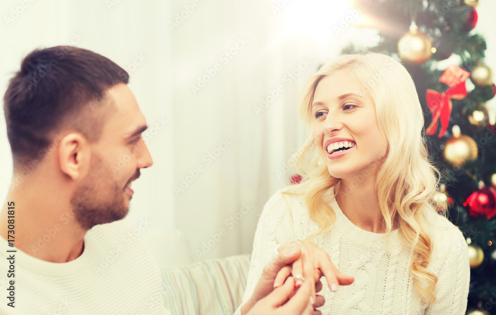 man giving woman engagement ring for christmas man giving woman engagement ring for christmas
