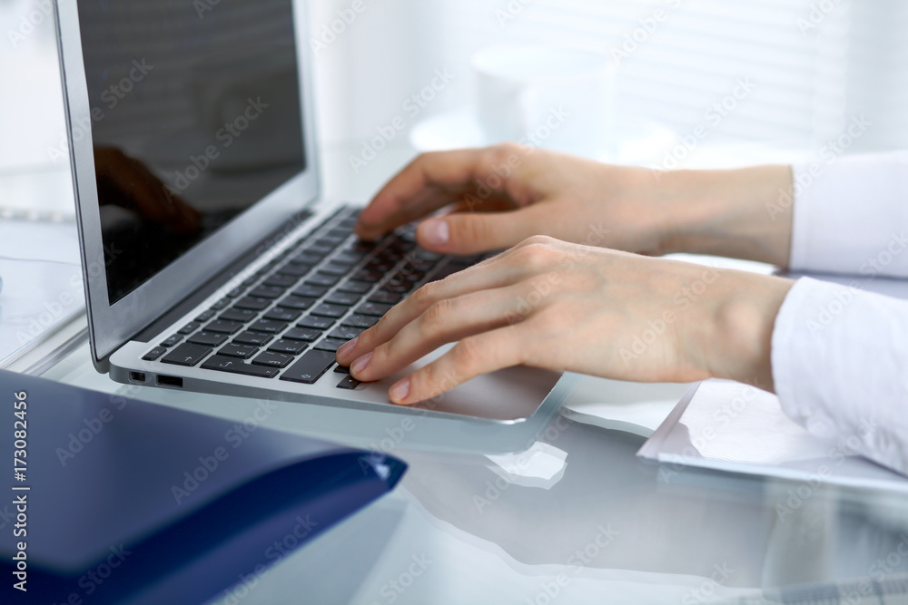 Close up of business woman hands typing on laptop computer Close up of business woman hands typing on laptop computer