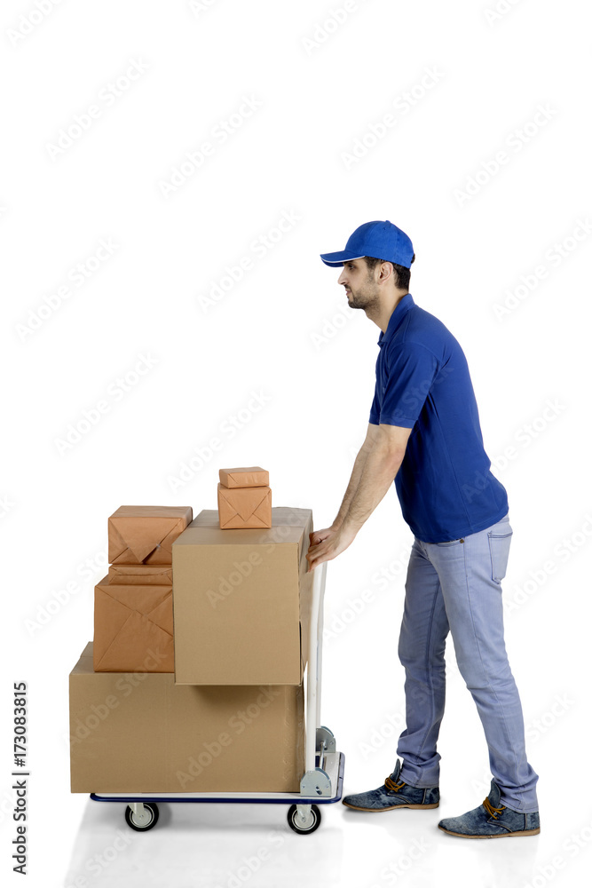 Caucasian courier pushing packages on studio Caucasian courier pushing packages on studio