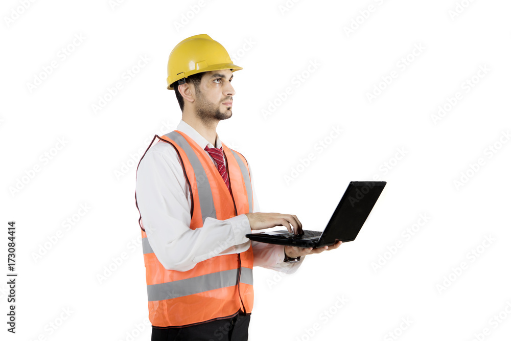Arabian foreman typing on a laptop Arabian foreman typing on a laptop