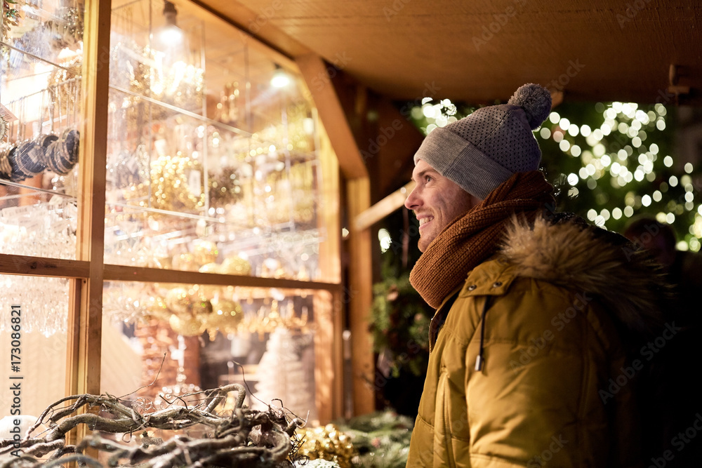 © Syda Productions - happy man looking at christmas market shop window