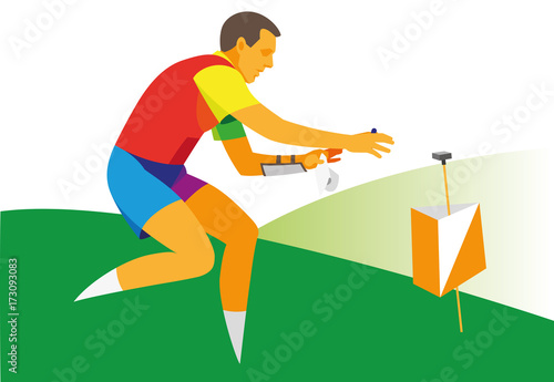 Young male athlete engaged in orienteering makes a mark at a checkpoint in forest