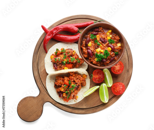 Chili con carne in bowl with tortillas and vegetables, isolated on white
