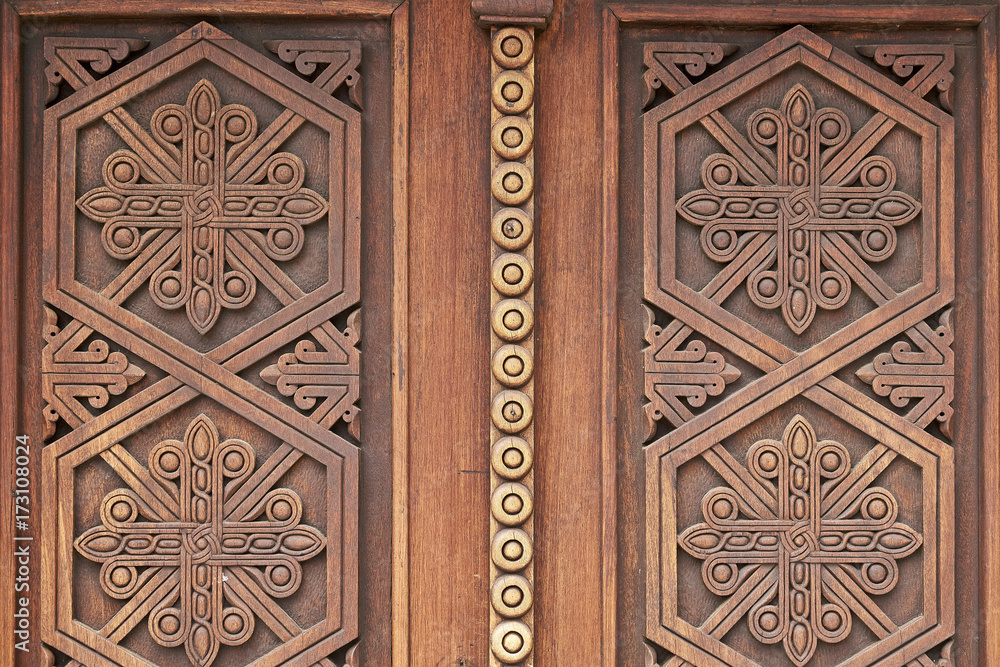 Beautiful ornaments on the wooden church doors in armenian medieval monastery Geghard close up       
