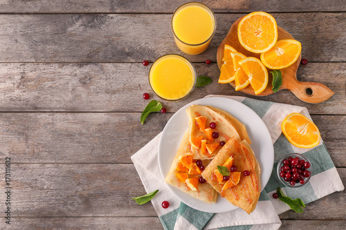 Wallpaper Mural Delicious pancakes with orange and cranberry on wooden table Torontodigital.ca