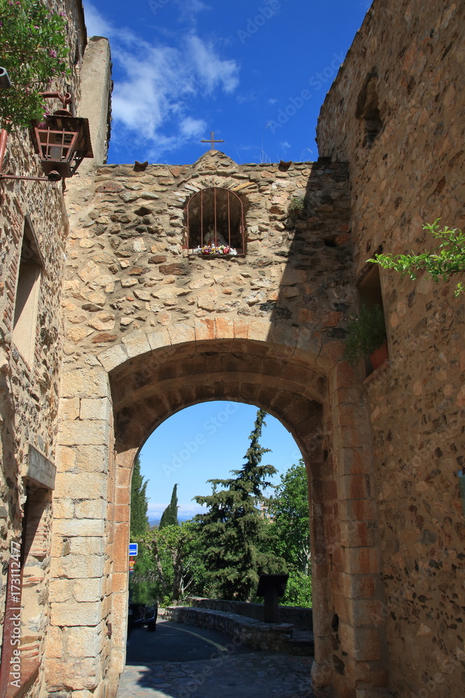 old entrance porch in french village of Castelnou in Pyrenees orientales, France