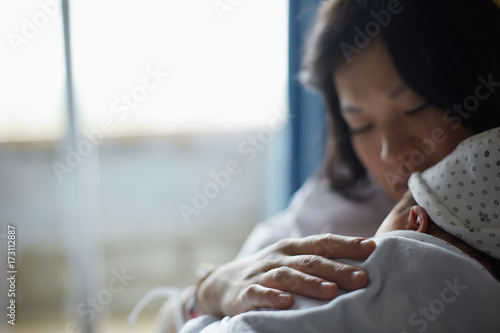 Mother and newborn in a hospital bedroom photo