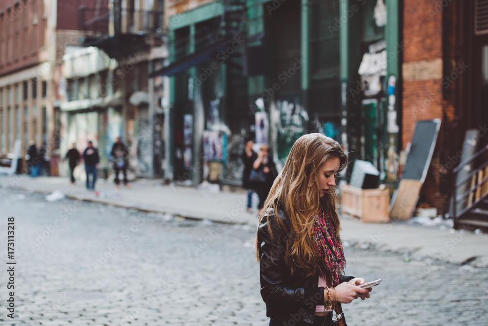 Young woman on her phone in the city Young woman on her phone in the city