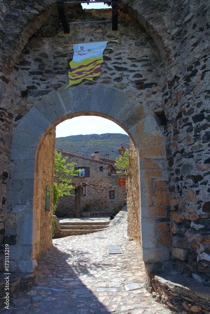 Naklejka premium Street in french village of Castelnou in Pyrenees orientales, France