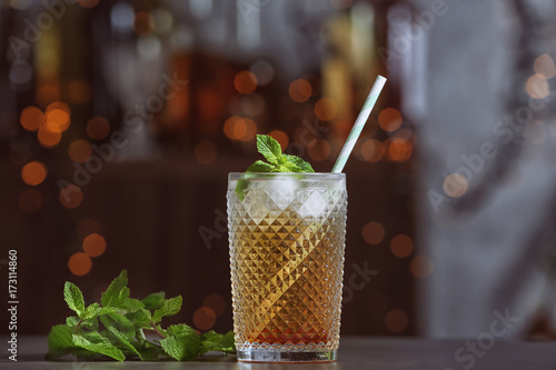 Foto Glass with mint julep on dark background