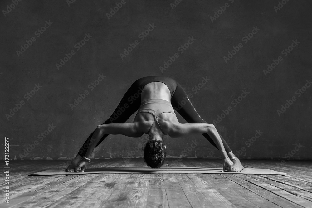 Young beautiful yoga female posing in studio - obrazy, fototapety, plakaty 