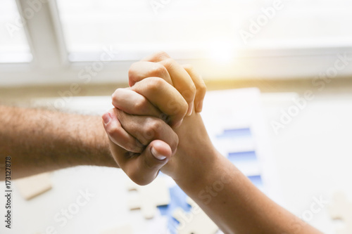  handshake the senior Manager and the employee above the Desk. business, people, paperwork, office and technology concept. Examining business graph and Finance management 