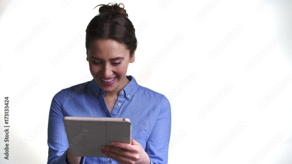 Shot Of Woman Using Digital Tablet Against White Background Shot Of Woman Using Digital Tablet Against White Background