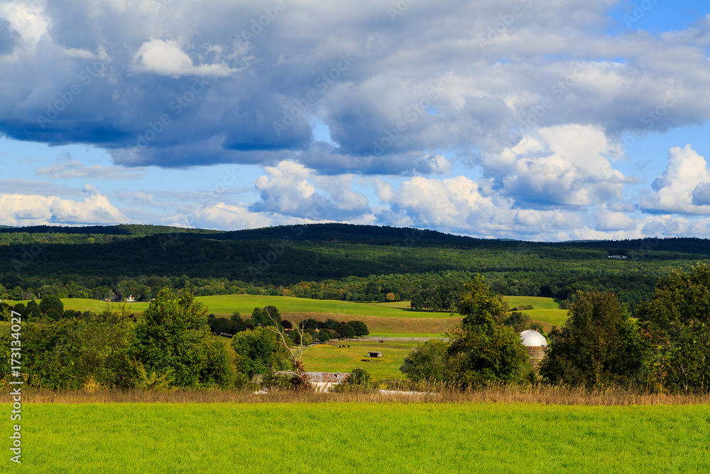 Obraz premium Hudson Valley skyline with farm land and meadows on a cloud filled summer day.