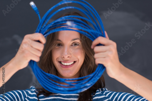 woman holding a internet cable in front of chalk drawing board
