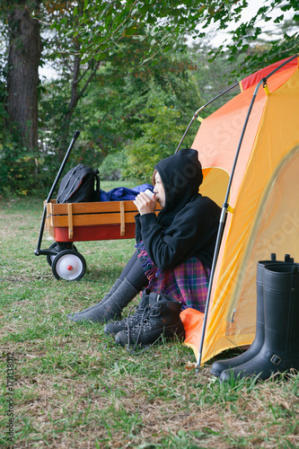 a women drinking coffee in camping tent