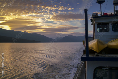 Cruising the Inside Passage Through Southeast Alaska. A boat trip traveling through the inside passage of Alaska during a glorious summer sunset.