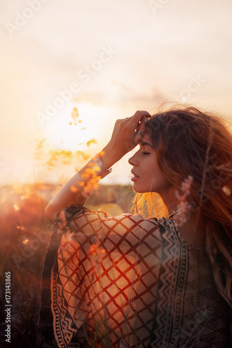 close up of beautiful young woman at sunset photo