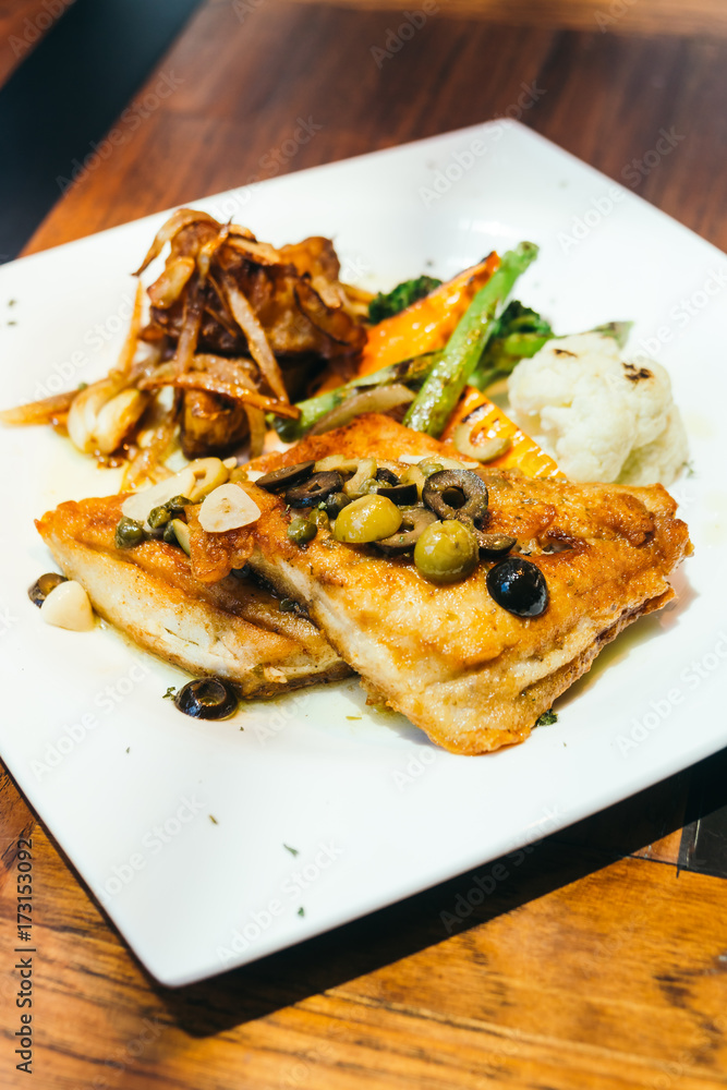 Grilled sea bass fish meat steak in white plate Grilled sea bass fish meat steak in white plate