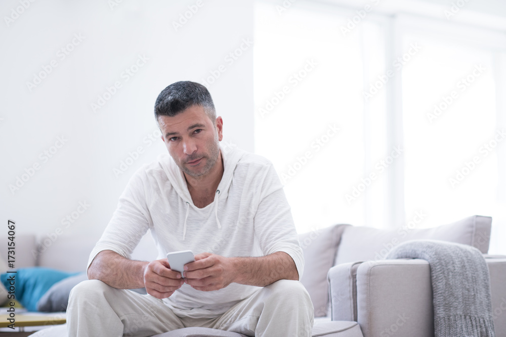 young man using a mobile phone  at home