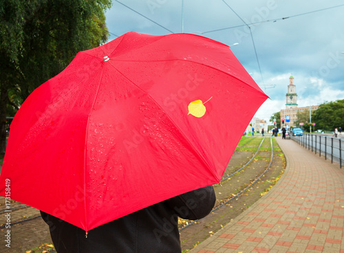 Red umbrella on a street.