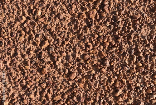 little brown stone on dry ground for brown background