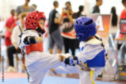 blurred background of Young Taekwondo athletes are fighting during contest © Nathakorn