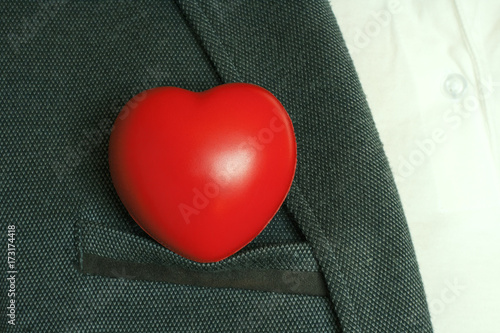 Bright red heart in the breast pocket of men's coat