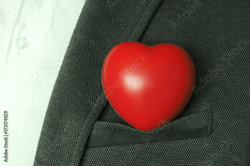Bright red heart in the breast pocket of men's coat