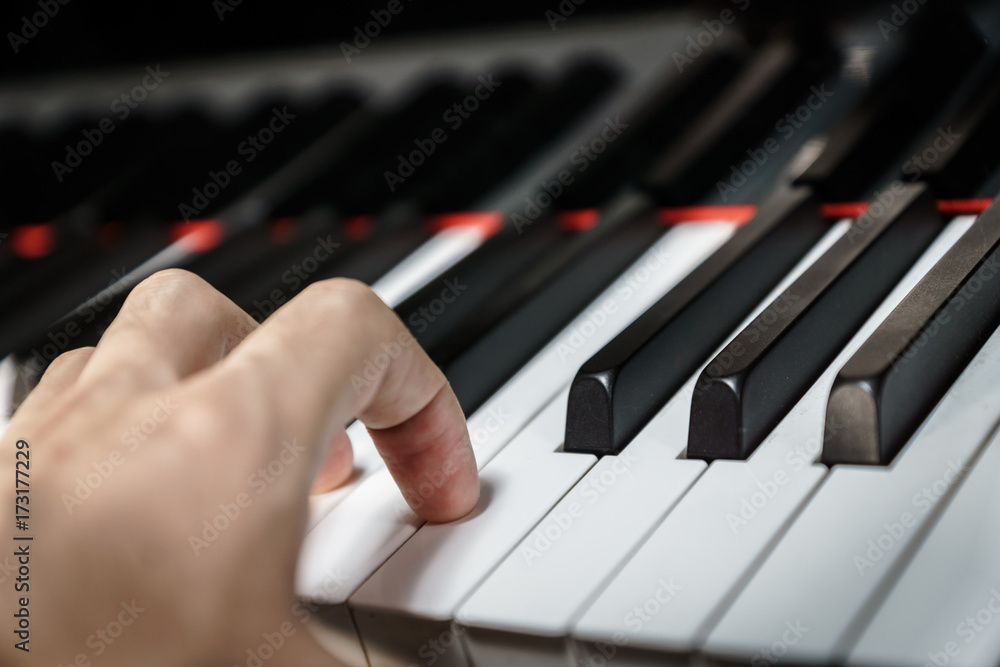 Fototapeta premium Piano keys on black classical grand piano - closeup for music production and recording