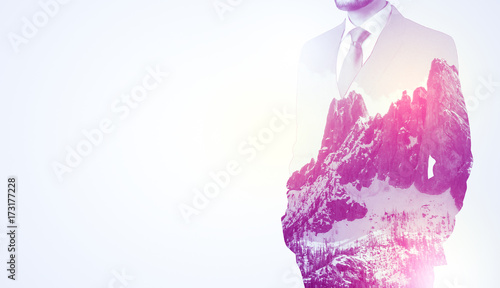 Businessman standing with mountain graphic