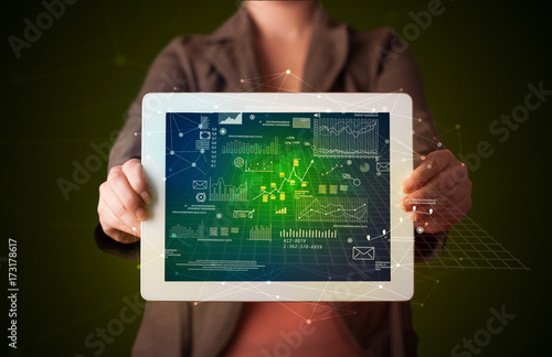 Woman holding tablet with business plan graphics