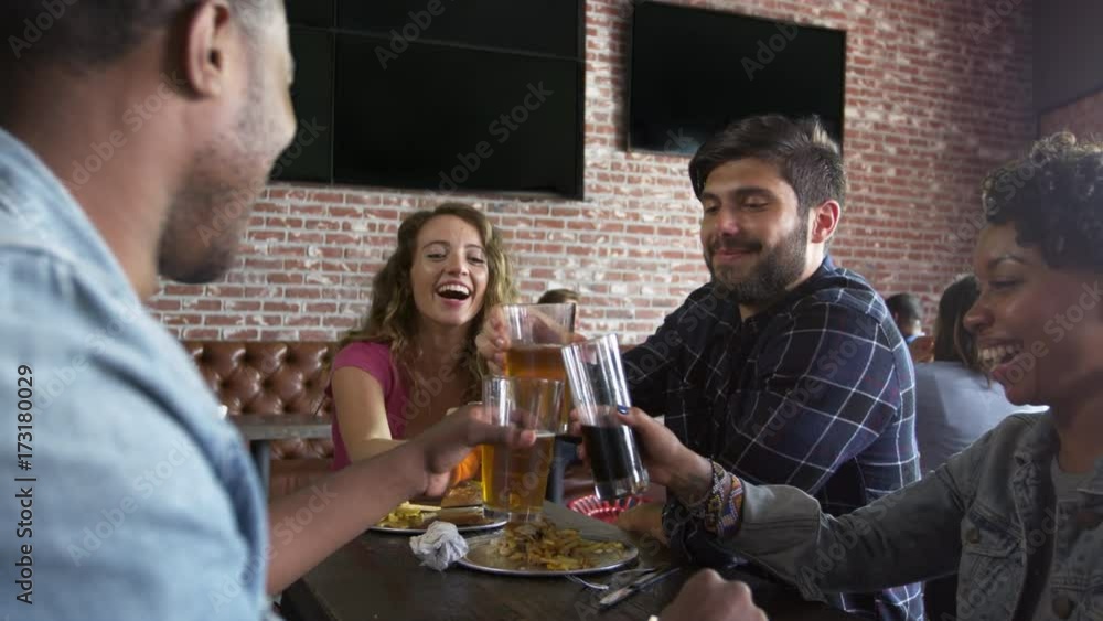 Friends Eating Out In Sports Bar With Screens Shot On R3D Friends Eating Out In Sports Bar With Screens Shot On R3D