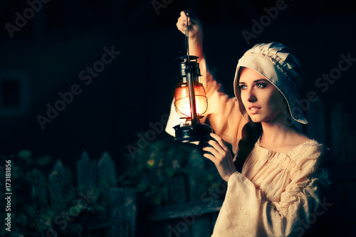 Medieval Woman with Vintage Lantern Outside at Night