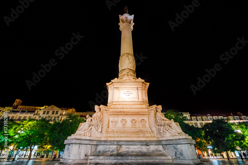 The twenty-three meter tall column with a statue of Dom Pedro IV in Praca Dom Pedro IV or Rossio Square in Lisbon downtown, Baixa district, Portugal, Europe. Urban scene by night.