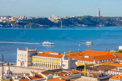 Lisbon aerial view from Sao Jorge Castle, Portugal, Europe. Close up of Cristo Rei in Almada, Tagus River and Comercio or Commerce Square with Rua Augusta Triumphal Arch on background. Urban skyline.