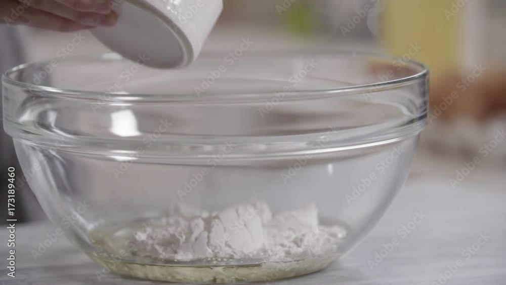 Slow motion, chef pours flour into bowl Slow motion, chef pours flour into bowl