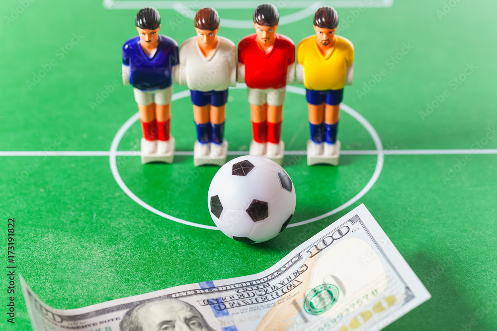 Fototapeta premium Table football .soccer players ball and dollars on the field.bookmaker concept