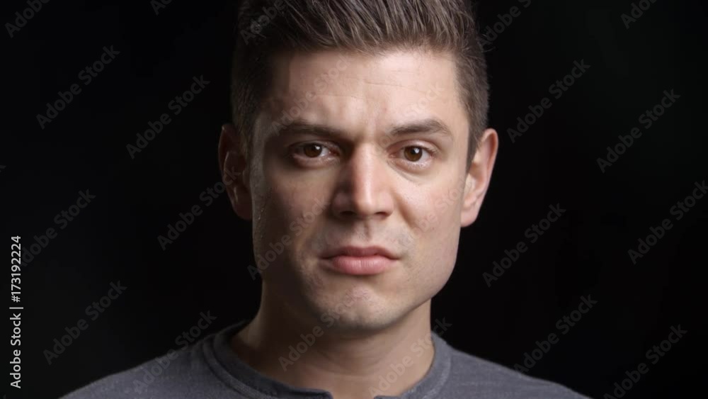 Studio Shot Of Tearful Man Against Black Background Studio Shot Of Tearful Man Against Black Background