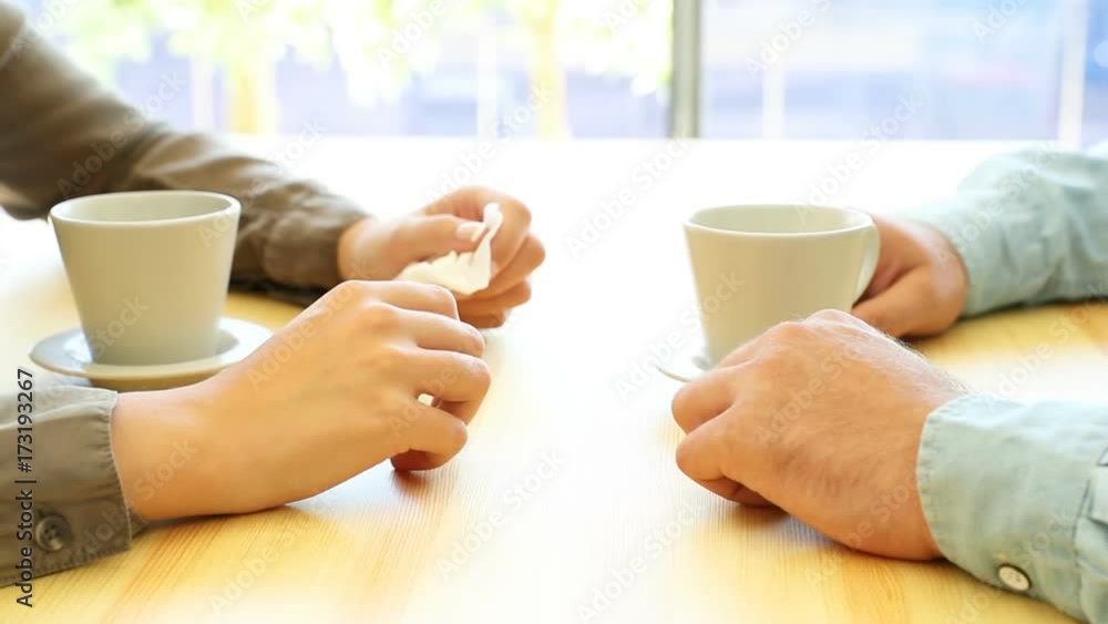 Close up of a sad woman and a good friend comforting her sitting in a restaurant interior Close up of a sad woman and a good friend comforting her sitting in a restaurant interior