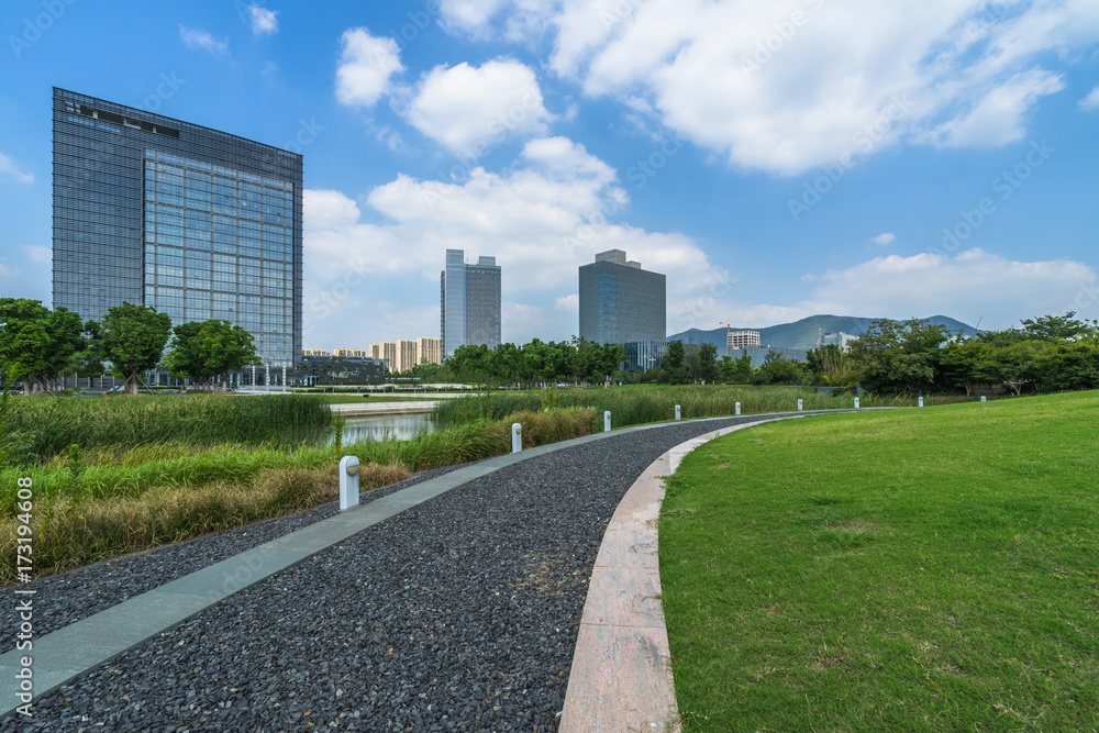 beautiful green meadow near modern office building.