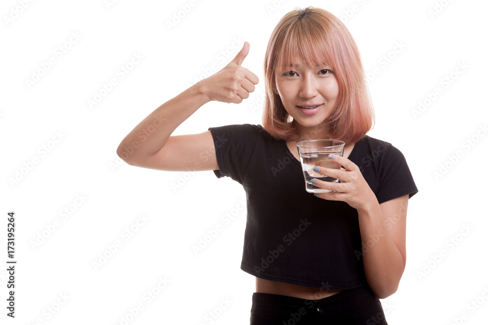 Obraz premium Young Asian woman thumbs up with a glass of drinking water.