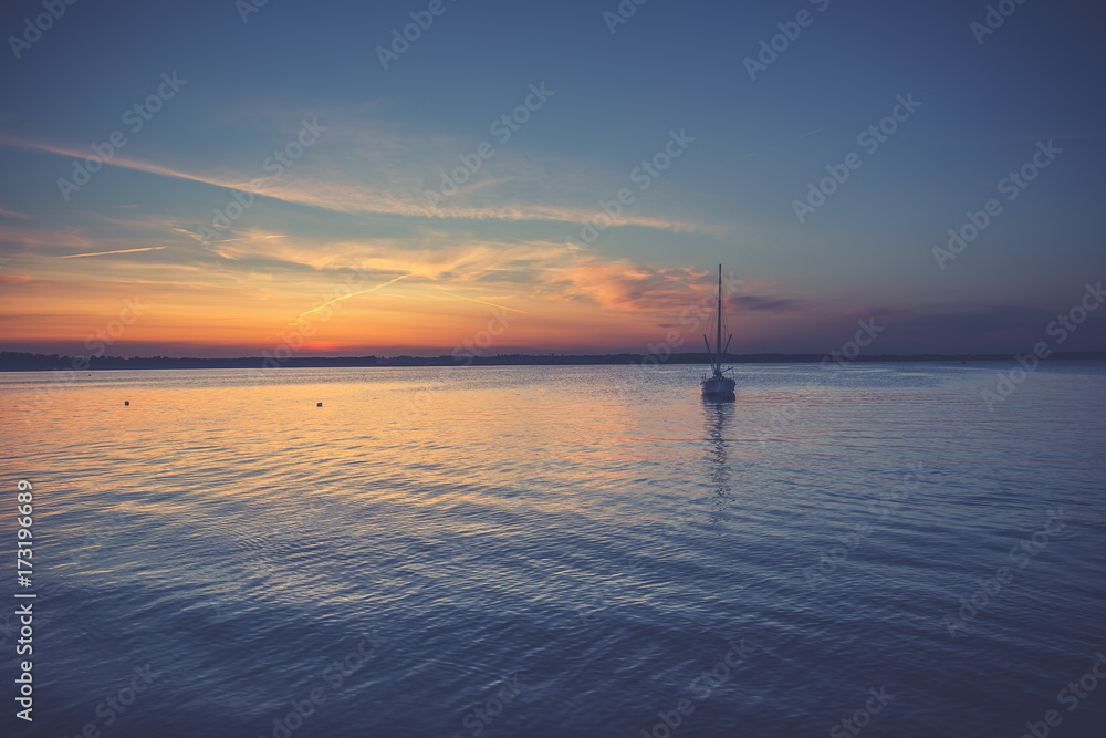 Yacht in the sea at sunset