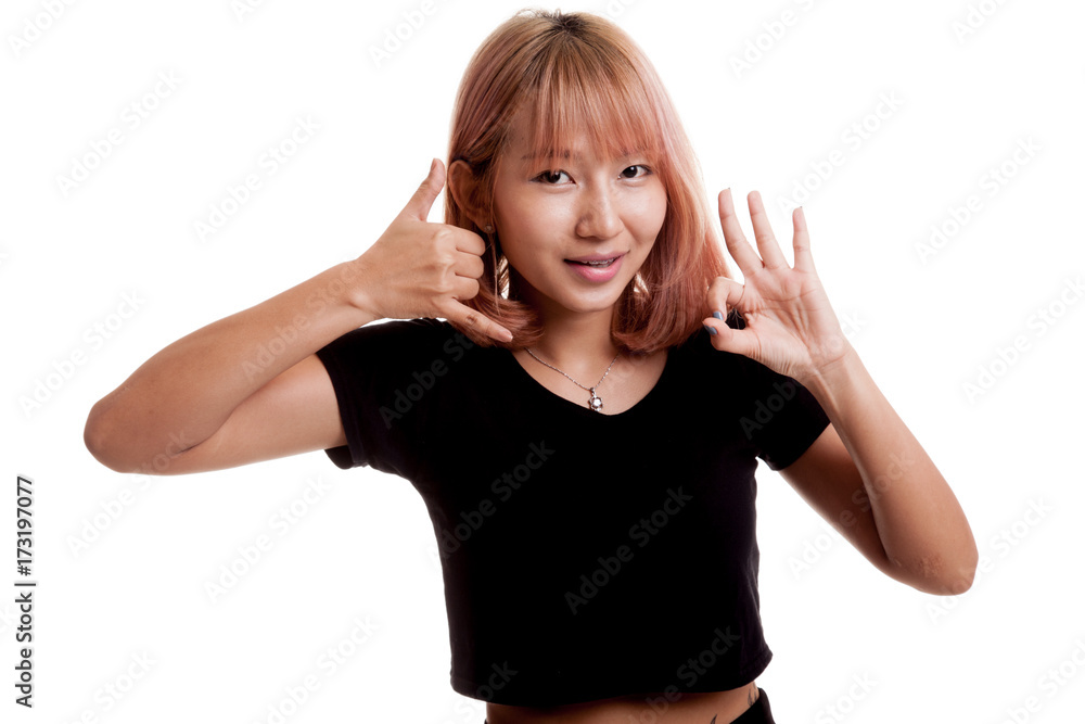 Young Asian woman show with phone gesture and OK sign. Young Asian woman show with phone gesture and OK sign.