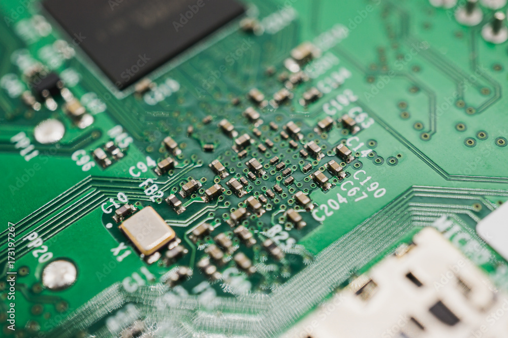 Green circuit board with small capacitors, resistors and microchips for electronic engineering. Green circuit board with small capacitors, resistors and microchips for electronic engineering.