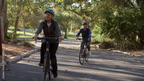 Wallpaper Mural Senior Couple Cycling Through Park In Slow Motion Torontodigital.ca