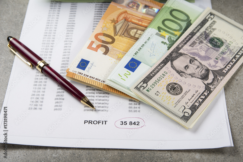 Profit and loss concept image of a pen, calculator and coins on financial documents. Profit and loss concept image of a pen, calculator and coins on financial documents.