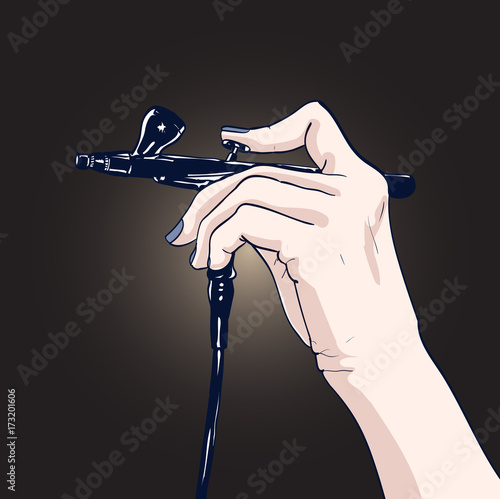 Hand holding a professional airbrush.